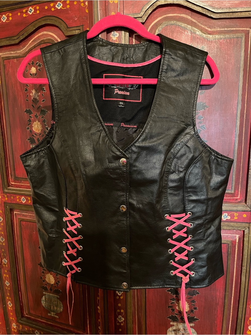 UNIK premium leather biker vest with pink leather lacing and pretty pink rose.